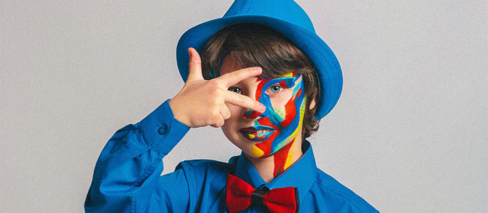 child in face paint and blue suite