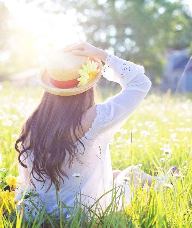 Woman in a field on a sunny spring day