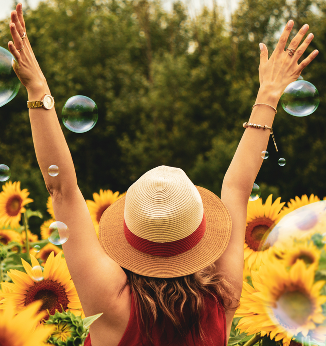 Girl in field with sunflowers